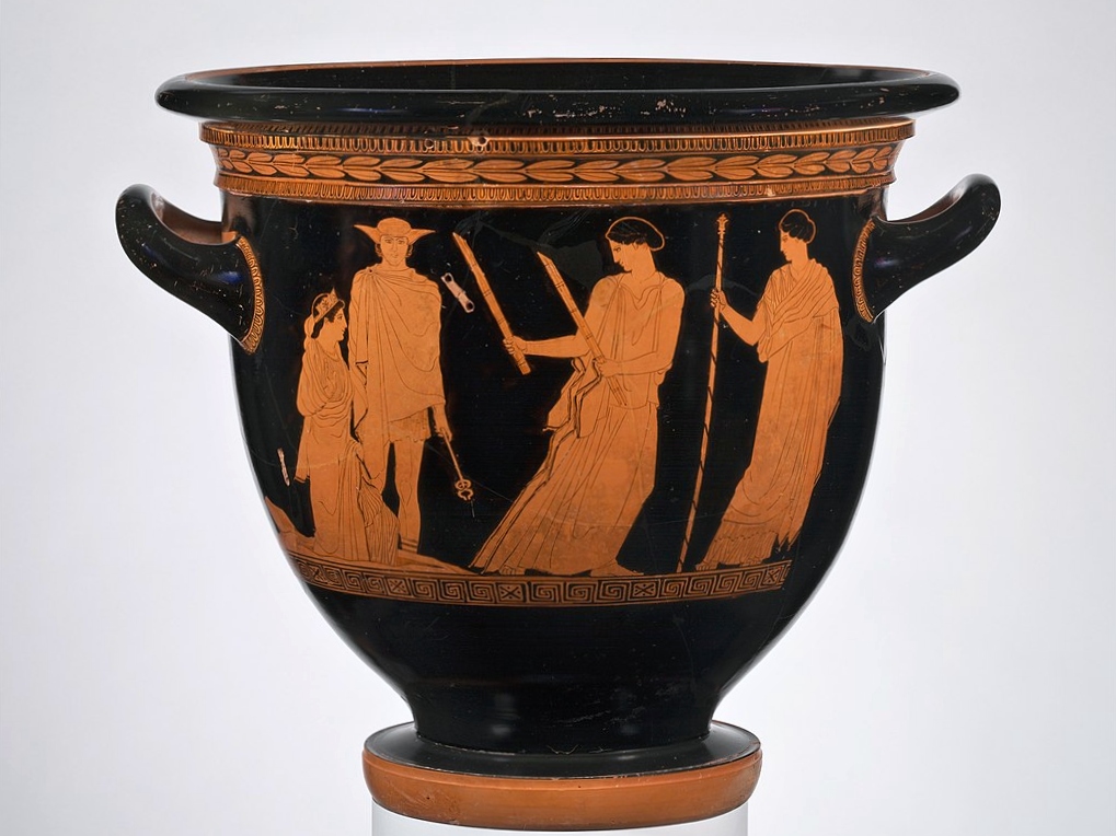 Atický červeno-figurový kratér, tedy nádoba na mísení vína s vosou. Persefoné (vlevo) se vrací na svět, pomáhá jí Hermés, asistuje Hetaké s pochodněmi, vpravo ji očekává její matka Démétér. Průměr 45 cm. Malíř Persefony, 440 před n. l. Metropolitní m